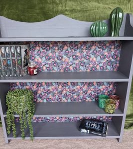 bookcase upcycled with purple paint and paisley material