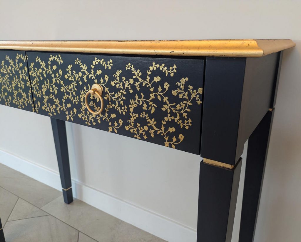 Dark blue console table with gold detailing